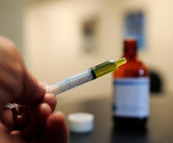 A syringe loaded with a dose of CBD oil is shown in a research laboratory at Colorado State University in Fort Collins, CO. (Credit: AP Photo/David Zalubowski)